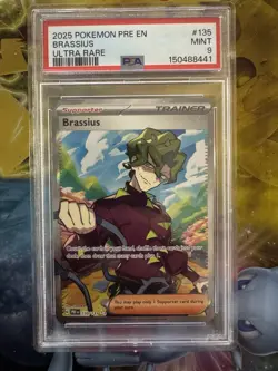 2025 Brassius 135/131 Prismatic Evolutions Ultra Rare Pokemon TCG Card PSA 9 - Image 1