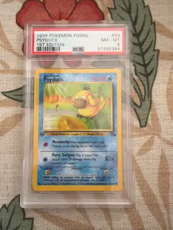 1999 POKEMON FOSSIL #53 PSYDUCK 1ST EDITION PSA 8 NM-MT - Image 1