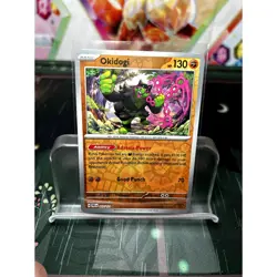 Okidogi 057/131 Holo Rare Prismatic Evolutions NM Pokemon TCG Card - Image 1