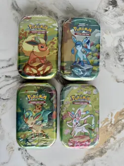 Pokemon TCG: Prismatic Evolutions Mini Tins x4 – Sealed - Image 1