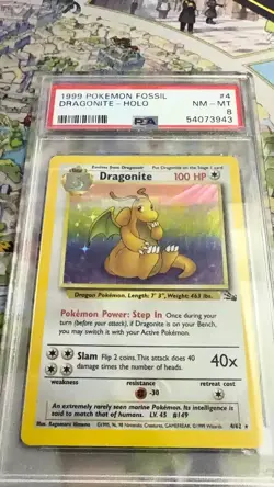 1999 POKEMON FOSSIL #4 DRAGONITE-HOLO PSA 8 - Image 1