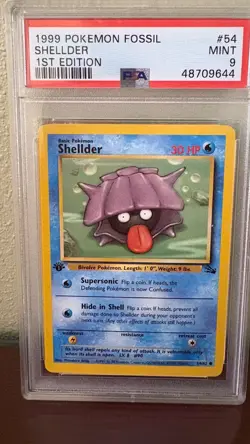 1999 POKEMON FOSSIL 1ST EDITION #54 SHELLDER PSA 9 MINT - Image 1