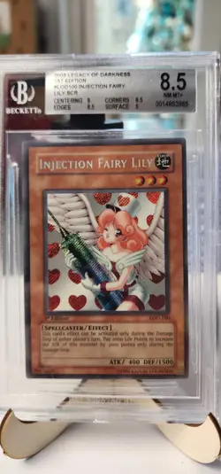 Beckett 8.5 Near Mint+ Injection Fairy Lily 1st Edition Yugioh Card #LOD-100 - Image 1