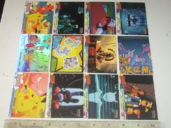 12 Topps 1999 Pokemon trading cards 1 holograph, 1 Sticker, 2 Puzzle, 9 Base Set - Image 1