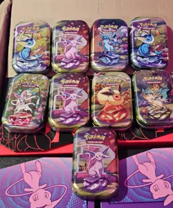 Pokemon Prismatic Evolutions Mini Tins Opened No Packs Of 9 Tins With coins. - Image 1