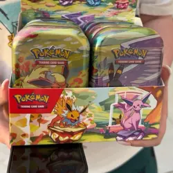 Pokemon TCG Prismatic Evolutions Full Set of 8 Sealed Mini Tins With Display - Image 1