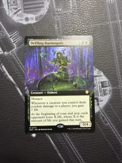 Defiling Daemogoth Commander: Secrets of Strixhaven Extended Art Rare - Image 1