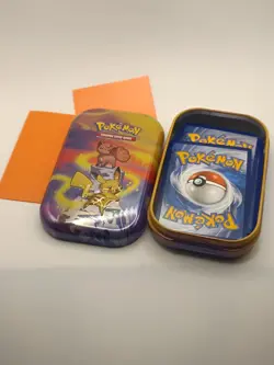 Pokemon Mystery Tin, 16 Cards, 1x V card, 2x sleeves, pikachu and vulpix tin art - Image 1