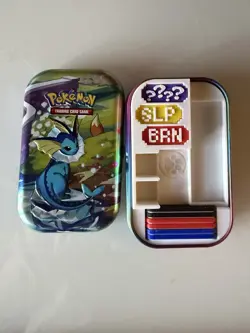 Vaporeon Prismatic Evolution Tin + Custom TCG Markers Pokemon - Image 1