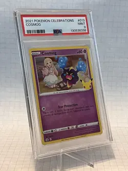 Pokemon TCG Cosmog Holo Rare Card Celebrations 013/025 PSA 9 - Image 1
