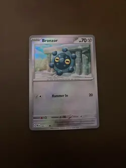 Bronzor 066/131 Sv: Prismatic Evolutions Regular Pokemon Tcg Card - Image 1