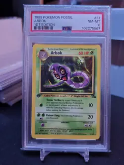 1999 POKEMON FOSSIL 1ST ED #31 ARBOK PSA 8 - Image 1