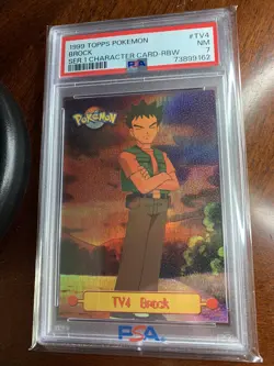 1999 Topps Pokemon #TV4 Brock Rainbow Foil Black Logo PSA 7 NM - Image 1