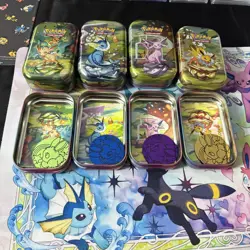 Set of 8 Prismatic Evolutions EMPTY Mini Tins With Pokemon Art Cards And Coins - Image 1