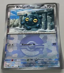 Pokemon Prismatic Evolutions Bronzor Basic #066PBALL Common Reverse Holo 066/131 - Image 1