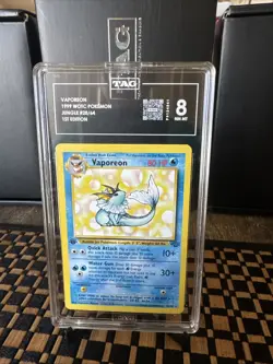 1999 POKEMON JUNGLE 1ST EDITION #28/64 VAPOREON TAG 8 - Image 1