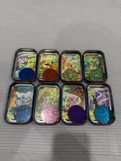 Prismatic Evolutions Full Set of Empty Tins w/ Art Cards & Coins - Image 2