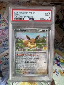 2025 POKEMON PRE EN-PRISMATIC EVOLUTIONS POKEMON DAY 2025 #074 EEVEE PSA 9 CARD - Image 1