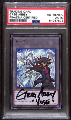 PSA Signed Greg Abbey Yu-Gi-Oh! Token QCDB-JPT12 Yusei and Stardust Dragon - Image 1