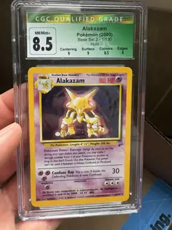 CGC 8.5 NM/MINT+ Alakazam 1/130 Base Set 2 Holo Pokemon Card - Image 1