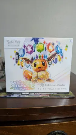 ripped Pokemon TCG Prismatic Evolutions Center Exclusive Elite Trainer Box - Image 1