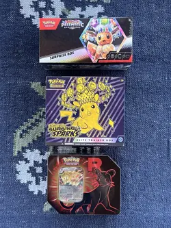 Pokemon Surging Sparks Elite Trainer Box, Prismatic Surprise Box, Rocket's Tin - Image 1
