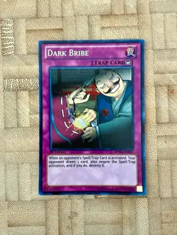Dark Bribe BPW2-EN087 Battle Pack 2: 1st Edition LP Super Rare - Image 1