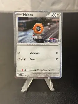 Pokemon Stellar Crown Stamped 102/142 Meltan Cosmos Holo - Image 1