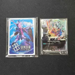 Gundam Card Game ST04-002 C Strike Gundam Kira Promo Card English and sleeves - Image 1