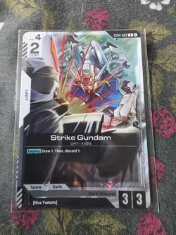Gundam Card Game ST04-002 C Strike Gundam Kira Promo Card English and sleeves - Image 1
