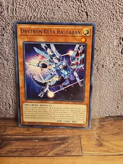 Drytron Beta Rastaban GEIM-EN025 Genesis Impact 1st Edition yugioh card - Image 1