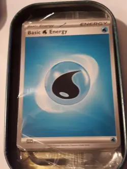 Pokemon cards in a tin. Sealed pack of basic energy cards with a free coin! - Image 3