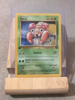 Pokemon TCG Card Paras 1st Edition Jungle 59/64 - MP In Top Loader - Image 1