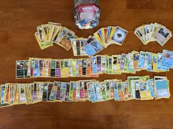 195 Assorted Pokemon Cards with Storage Tin - Image 1