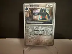2024 Pokemon TCG Bronzong 127 Surging Sparks Reverse Holo Card NM+ - Image 1