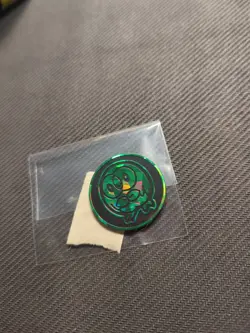 Green Rowlett Holo Cracked Ice Pokemon Coin - Image 1