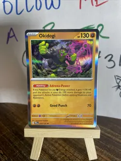 Okidogi 057/131 Holo Rare Prismatic Evolutions NM Pokemon TCG Card - Image 1