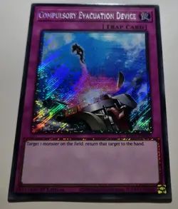 Yugioh! Compulsory Evac.Device 1st Ed. RA01-EN069 Platinum Secret Rare 25th - Image 1