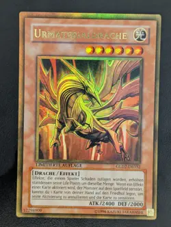 Urmaterialdrache GLD2-DE032 Gold Rare Deutsch EX YUGIOH - Image 1