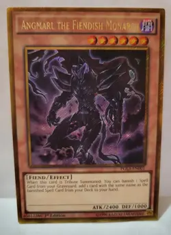 YUGIOH ANGMARL THE FIENDISH MONARCH PGL3-EN001 1ST EDITION SECRET GOLD - Image 1