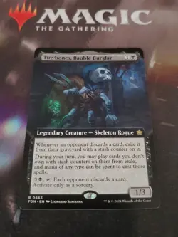 Mtg. Tinybones, Bauble Burglar. Borderless. Foundations. Pack Fresh - Image 1