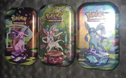 The Pokemon TCG Scarlet & Violet Prismatic Evolutions Mini 3 Tins Sealed - Image 1